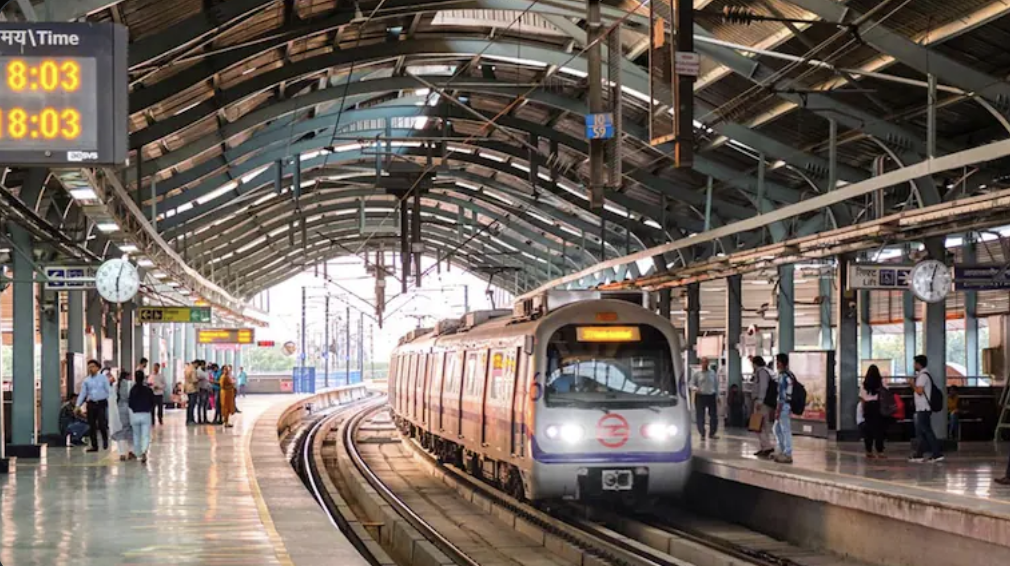 Delhi Metro train at platform with security personnel