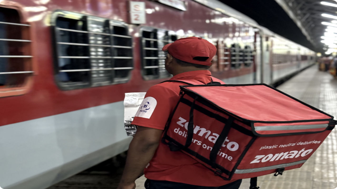 Food delivery to train seats via MakeMyTrip and Zomato partnership.