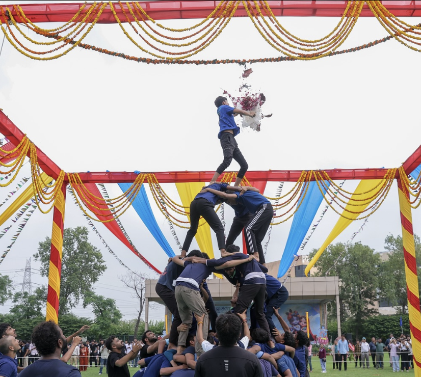 Students celebrating Janmashtami with Matki Phod competition at SGT University.