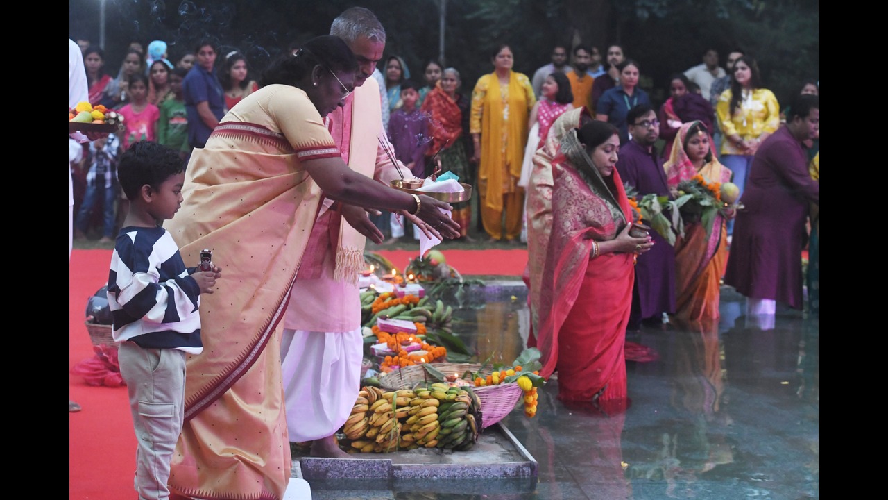 President Droupadi Murmu offering Arghya to the setting Sun during Chhath Puja at Rashtrapati Bhavan.