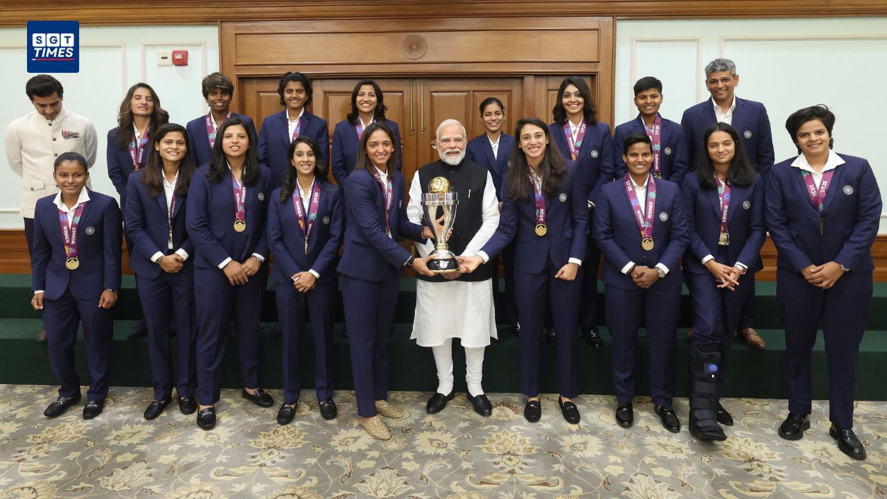 PM Modi with Indian women’s cricket team holding “Namo 1” jersey.