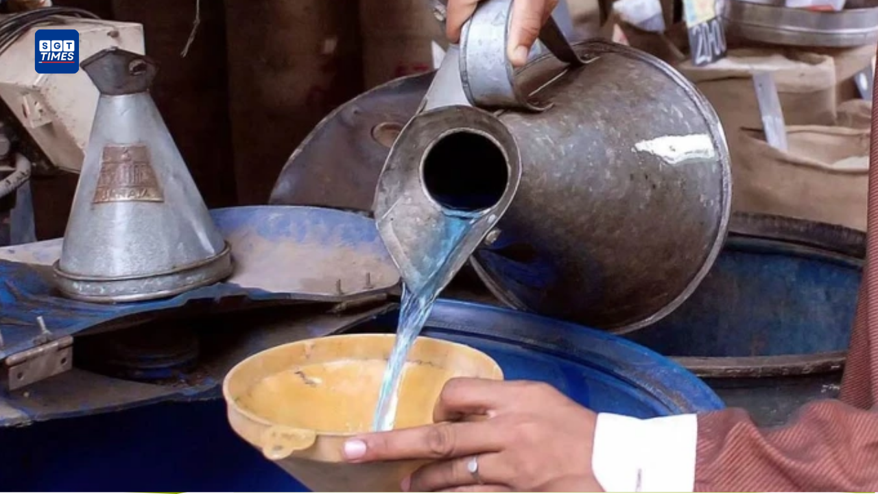 Petrol pump worker filling kerosene container at fuel station