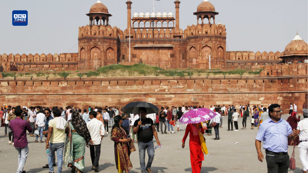 People covering themselves while walking during extreme heatwave conditions in Delhi-NCR.