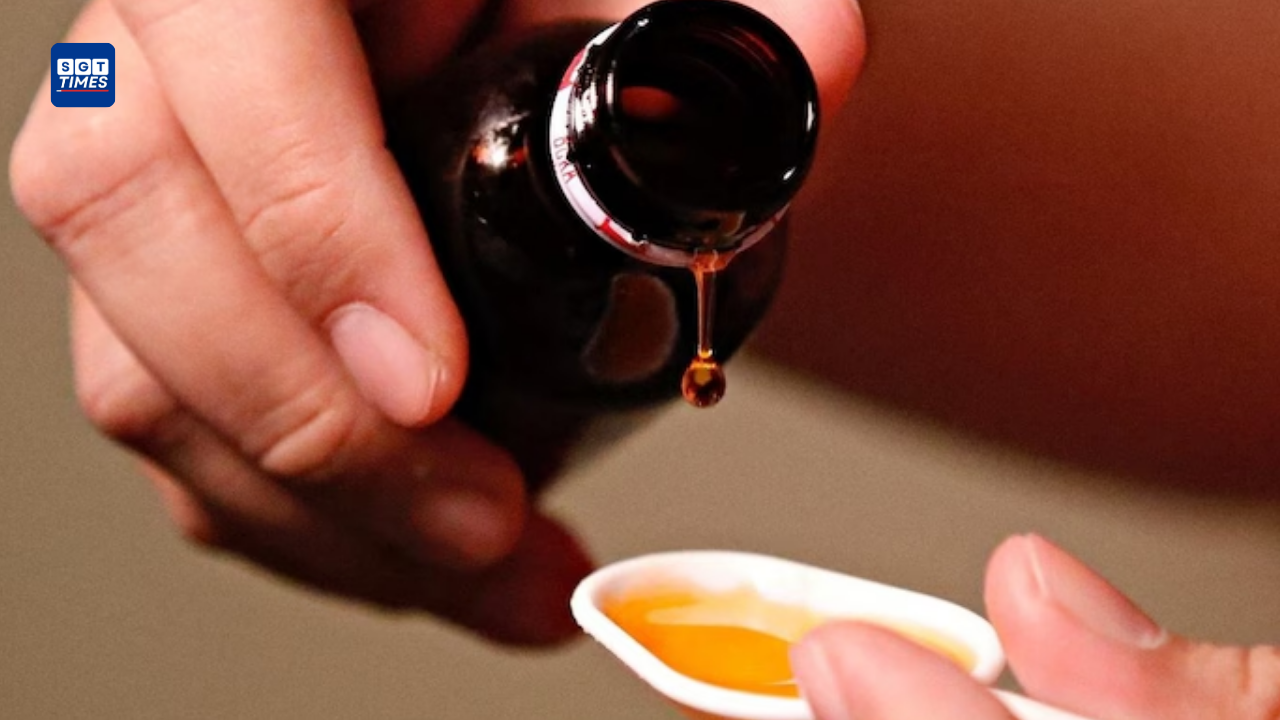 Pharmacist holding cough syrup bottles as the government makes prescriptions mandatory for syrup-based medicines in India.